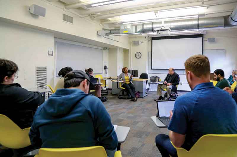 Assistant Professor of Communication Katherine Elder and Political Science Lecturer Tim Allison give a lecture to a political science class.