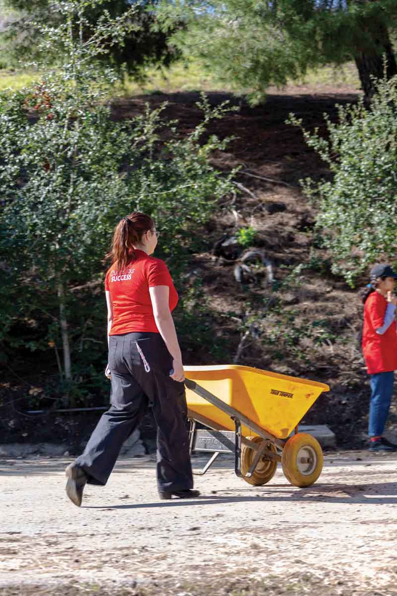 Student volunteers hauled out old hay, cleared mud from a clogged drainage channel, and spent time outdoors and with the therapy horses.