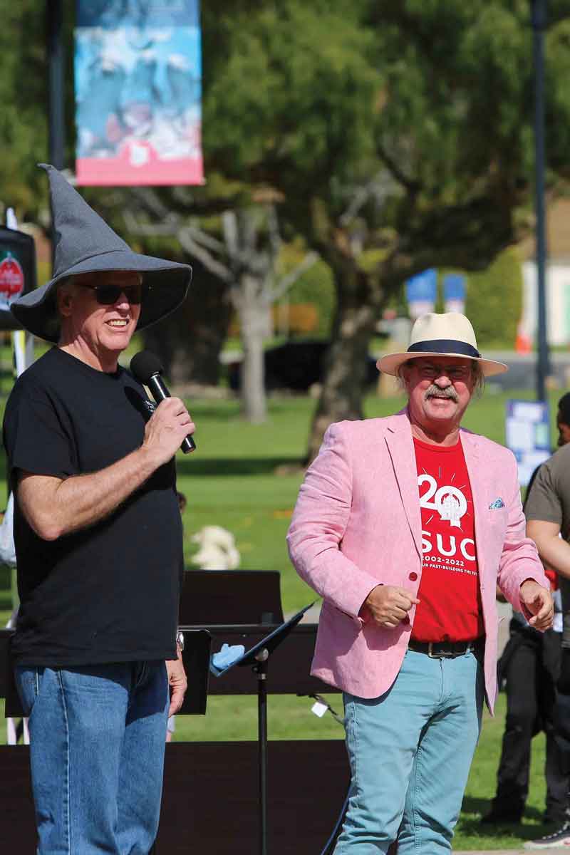 Acting Dean of the School of Arts & Sciences Phil Hampton wears his STEAM Carnival Wizard hat with Provost Mitch Avila watching.