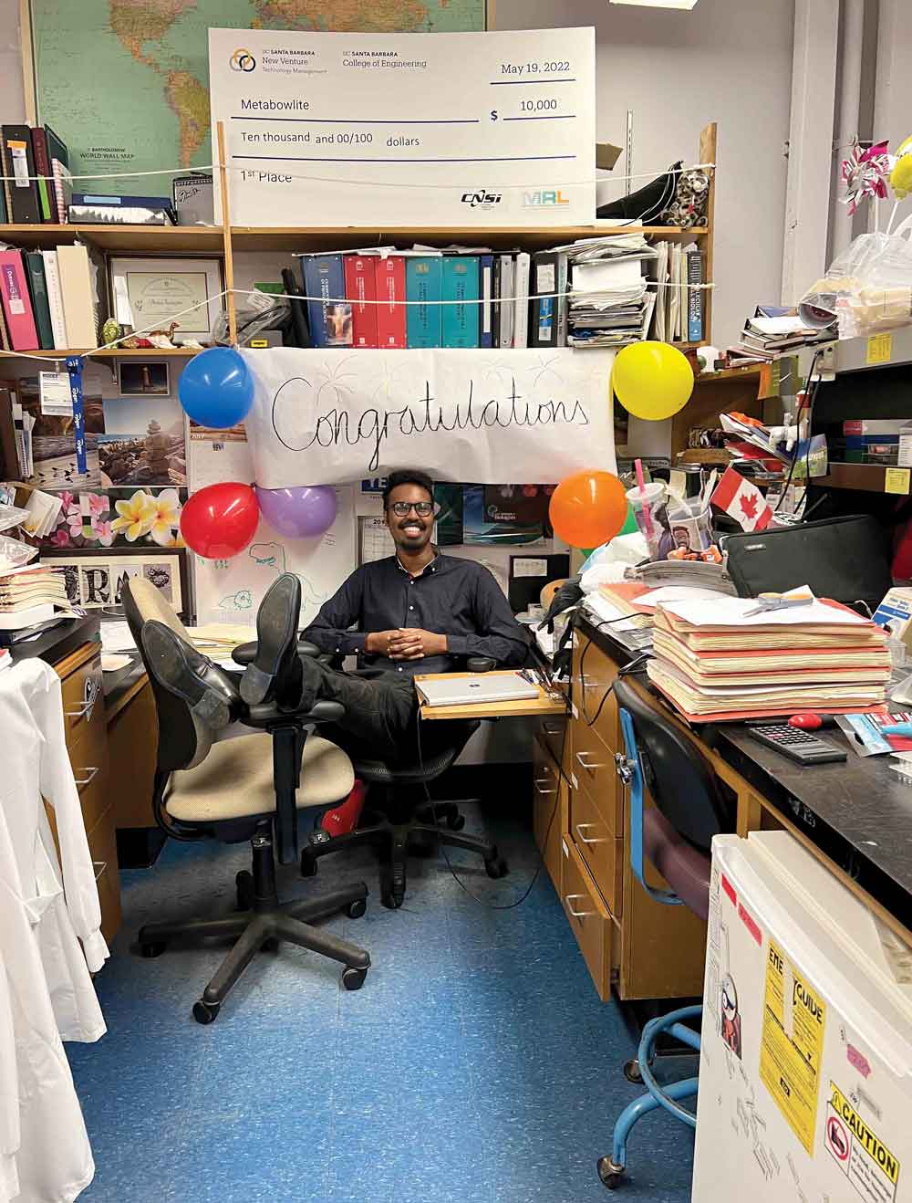 Mohamed Faynus in his office after coworkers decorated it to congratulate him on his Ph.D. Mohamed Faynus in his office after coworkers decorated it to congratulate him on his Ph.D.